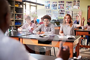 Male High School Tutor Teaching Students In Biology Class