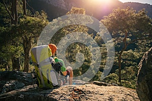 Male hiker enjoying sunset over mountains