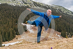 Male hiker enjoys the view at Carpathian mountains at early spring