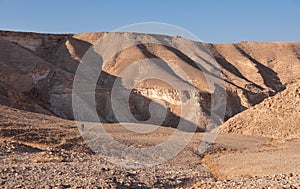 Male hiker on a hiking trail in a remote desert region.