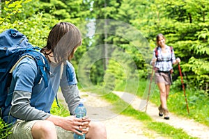 Male hiker looking back waiting the girl