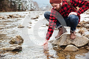 Male hiker testing water