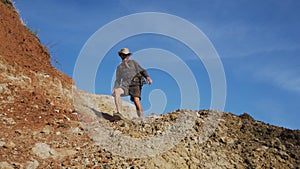 Male hiker walks in mountains