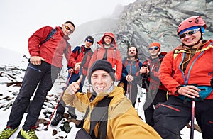 Male hikers making selfie in winter mountains.