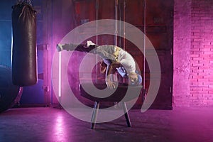 Male hip hop dancer on head stand doing acrobatic stunt