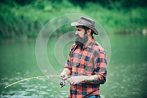 Male hobby. Man at riverside enjoy peaceful idyllic landscape while fishing. Difference between fly fishing and regular