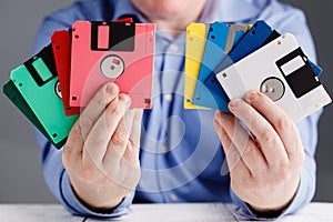 Male hold floppy disk in hands, retro storage