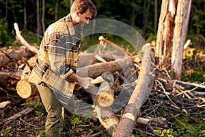 Male holding heavy ax. Axe in lumberjack hands chopping or cutting wood trunks