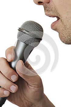 Male holding a microphone and singing photo