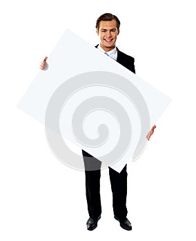 Male holding tilted blank billboard