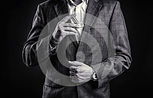 Male holding up bottle perfume. Hand in with wrist watch in a business suit. Perfume or cologne bottle and perfumery
