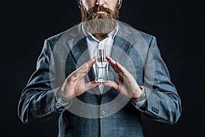 Male holding up bottle of perfume. Man perfume, fragrance. Perfume or cologne bottle and perfumery, cosmetics, scent