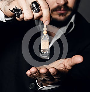 Male holding up bottle of perfume. Perfume or cologne bottle and perfumery, cosmetics