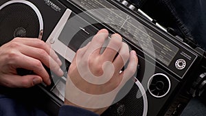 Male Holds Old Audio Tape Recorder in Hands with Magnetic Audio Cassette Inside