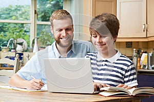 Male Home Tutor Helping Boy With Studies photo