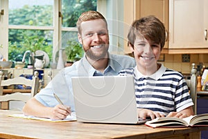 Male Home Tutor Helping Boy With Studies photo