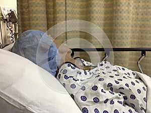 Male hospital patient before surgery wearing cap