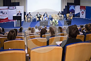 Male Host Speaking On Stage During Business Conference in Large Congress Hall.
