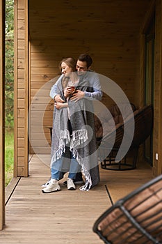 Male hugging his girlfriend while she drinking tea