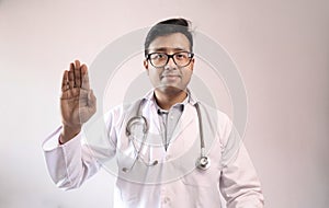 Male indian doctor in white coat and stethoscope swearing hippocratic oath photo