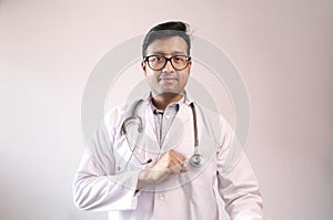 Male indian doctor in white coat and stethoscope swearing hippocratic oath