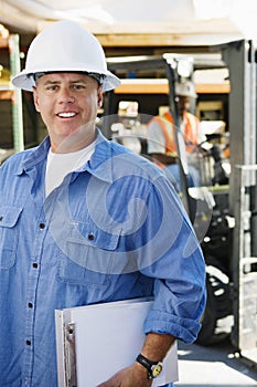 Male Industrial Worker Holding Clipboard
