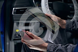 Male inspecting board computer system in the workshop
