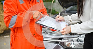 male insurance officer came to help inspect a customer's car that had an accident.