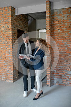 Male investor in a black suit scrutinizing the contract