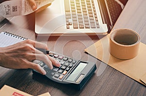 Male investors are calculating investment cost statistics with calculators
