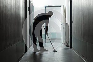 Male Janitor Cleaning Corridor photo