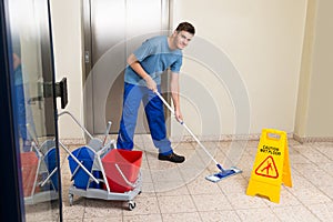 Male Janitor Mopping Floor