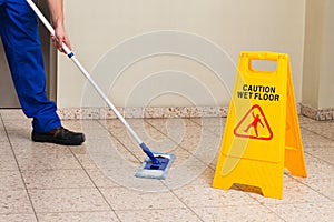 Male Janitor Mopping Floor