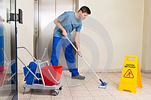 Male Janitor Mopping Floor photo