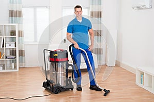 Male Janitor Vacuuming Floor