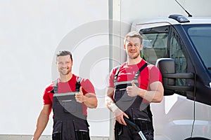 Male Janitors Showing Thumbs Up Sign At Outdoors