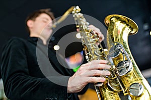 Male jazz musician playing a saxophone in a restaurant