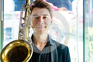 Male jazz musician playing a saxophone in a restaurant