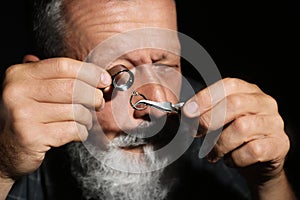 Male jeweler  diamond ring in workshop, closeup view