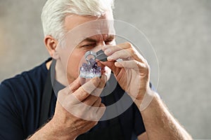 Male jeweler evaluating semi precious gemstone