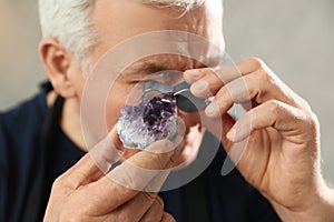 Male jeweler evaluating semi precious gemstone in workshop