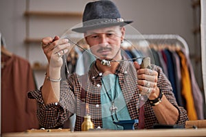 male jeweller examining polished ring