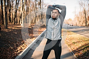 Male jogger doing exercise on workout outdoors