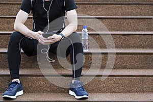 Male jogger taking a break from running workout.