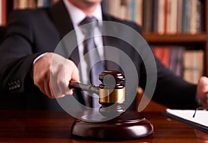 Male judge in a courtroom striking the gavel