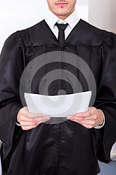Male Judge Holding Documents