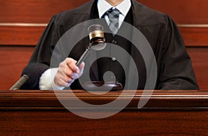 Male judge striking the gavel after giving verdict in the courtroom