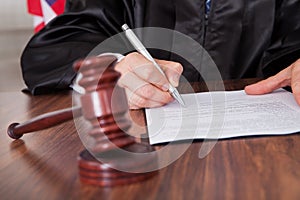 Male judge writing on paper