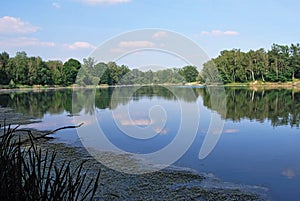 Male Kalisovo jezero lake with blue sky and clouds near Bohumin