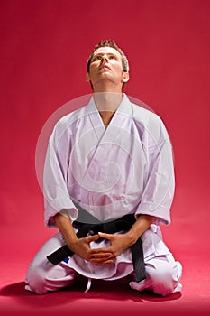 Male karate expert kneeling photo